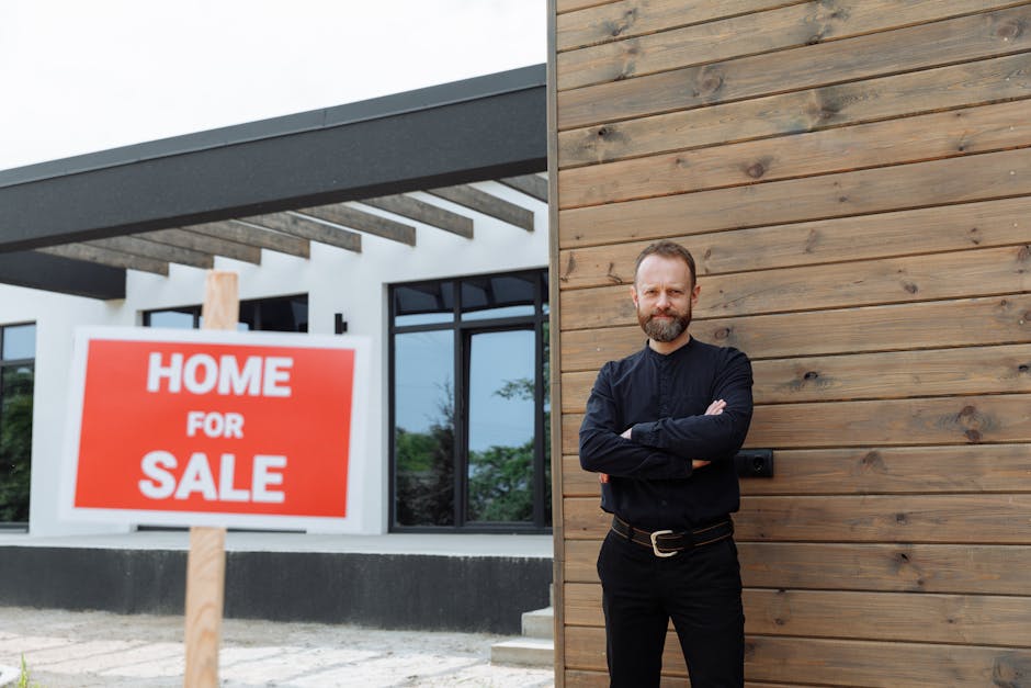 Real estate agent standing by a modern home with a 'Home for Sale' sign