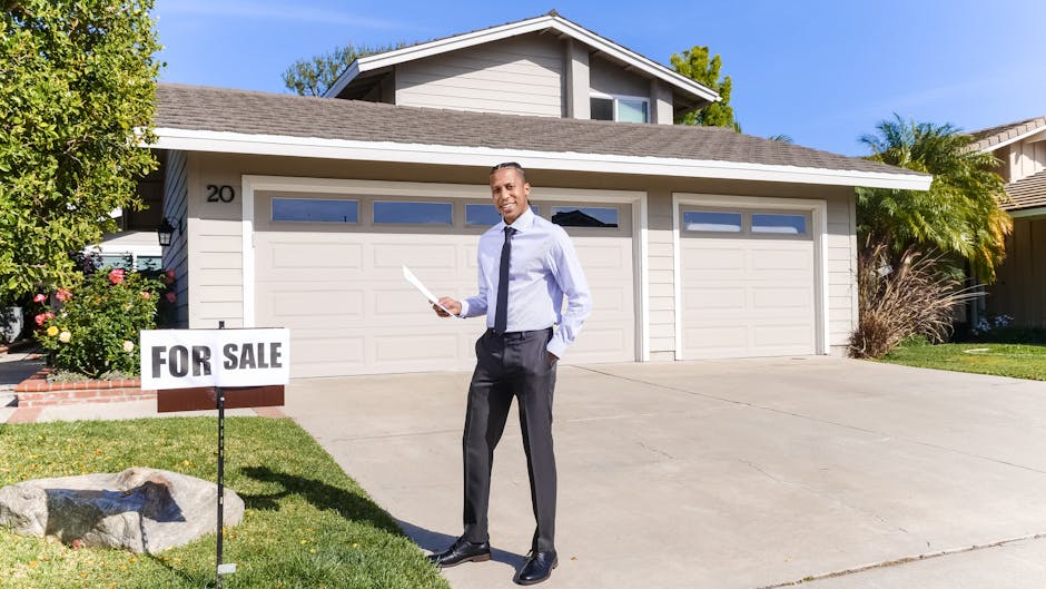 Real estate agent standing outside a house with a for sale sign in the driveway