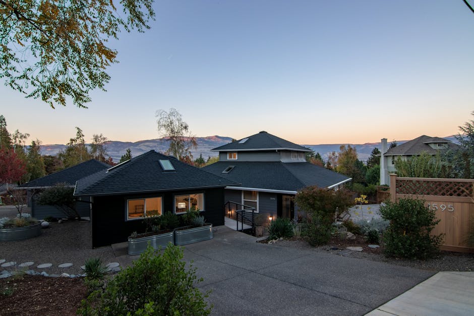 Elegant suburban house with spacious driveway and stunning mountain views at sunset