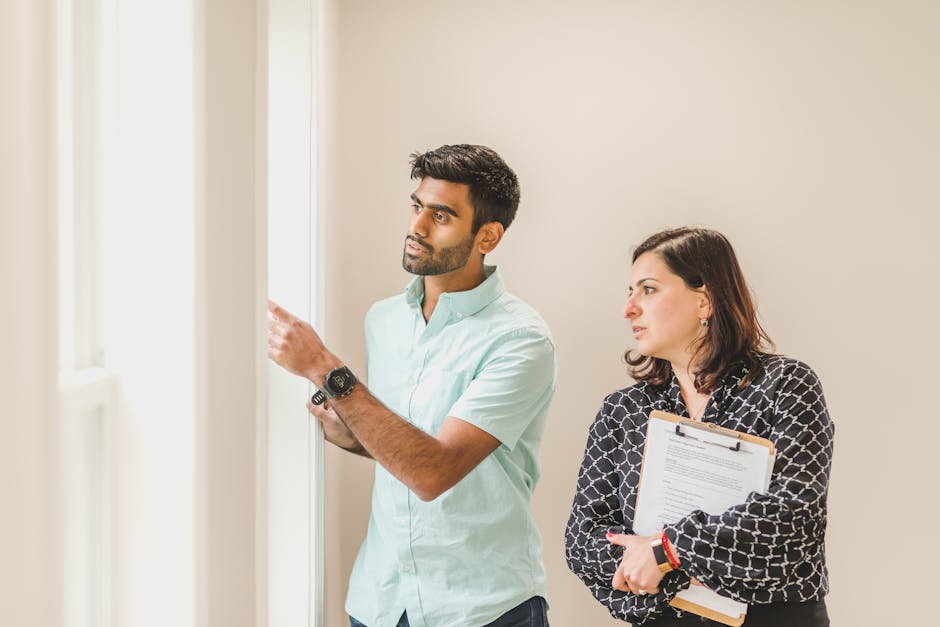 Realtor showing a property to a client indoors, discussing details