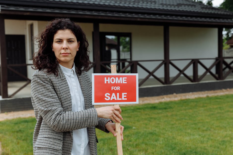 Confident real estate agent with sale sign in front of a house